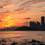 Tourists walking at sunset on Haeundae Beach in Busan, South Korea